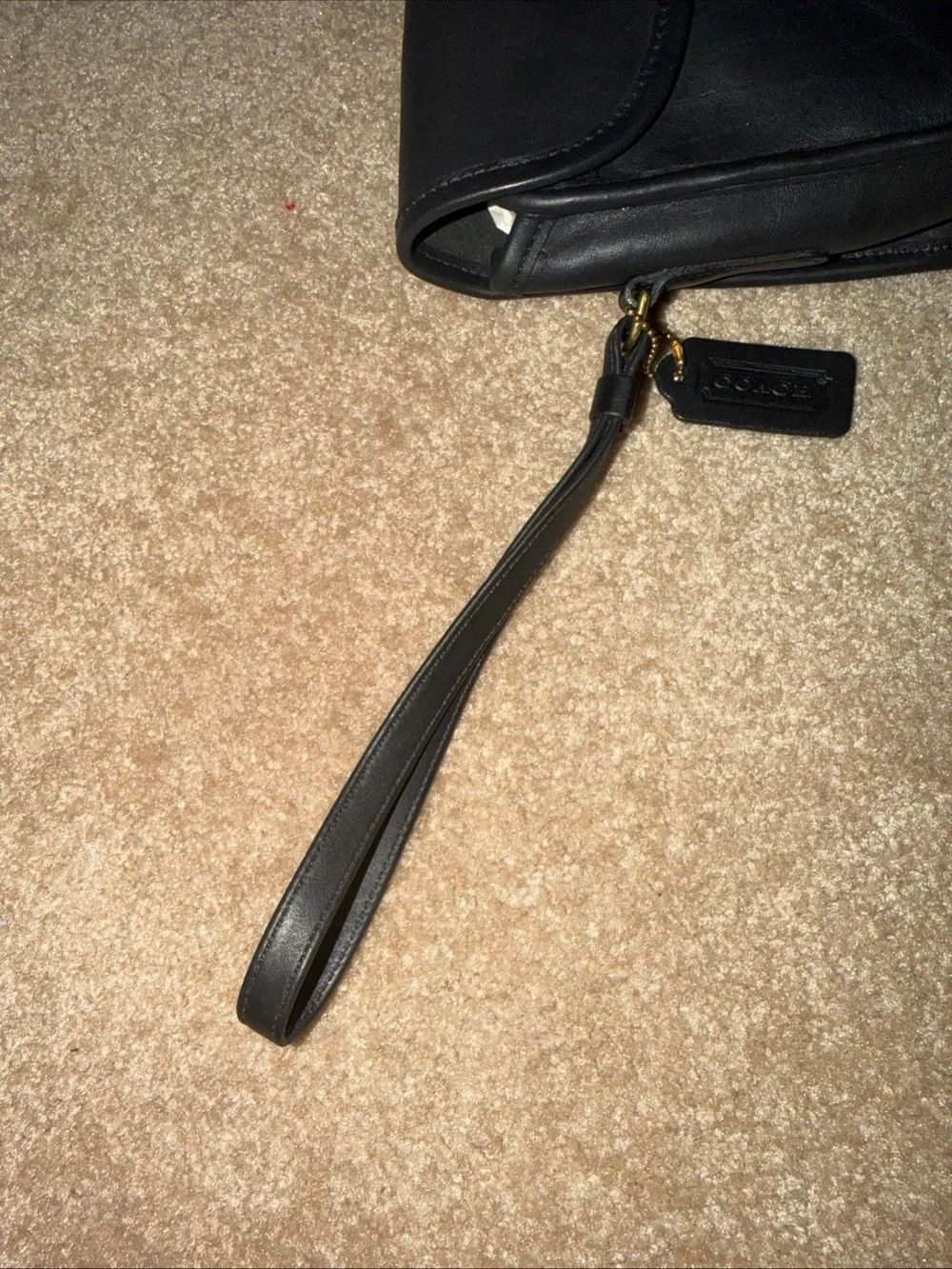 NWOT vintage black leather Coach wristlet features a classic a detachable strap